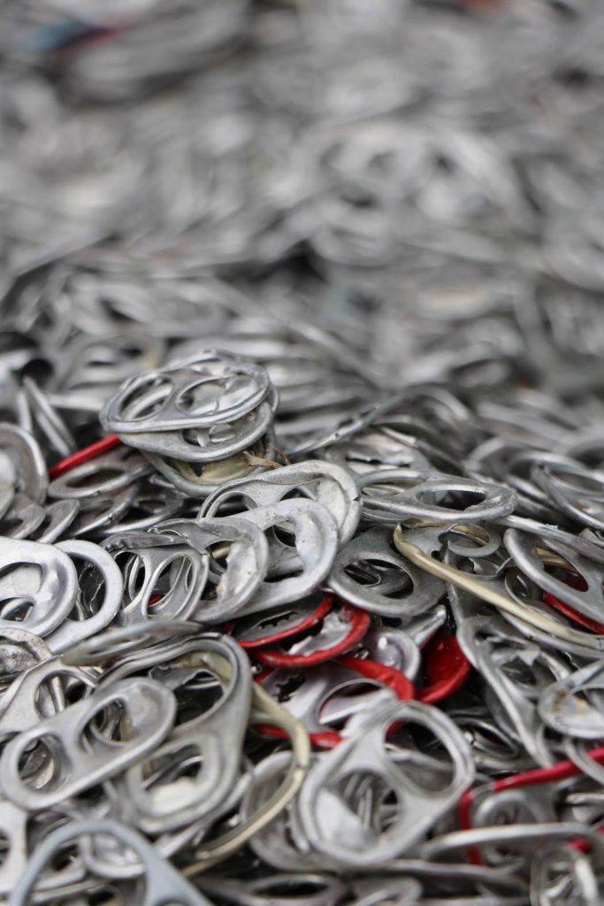 GLE scrap metal recycling center aluminum can tabs in a large pile